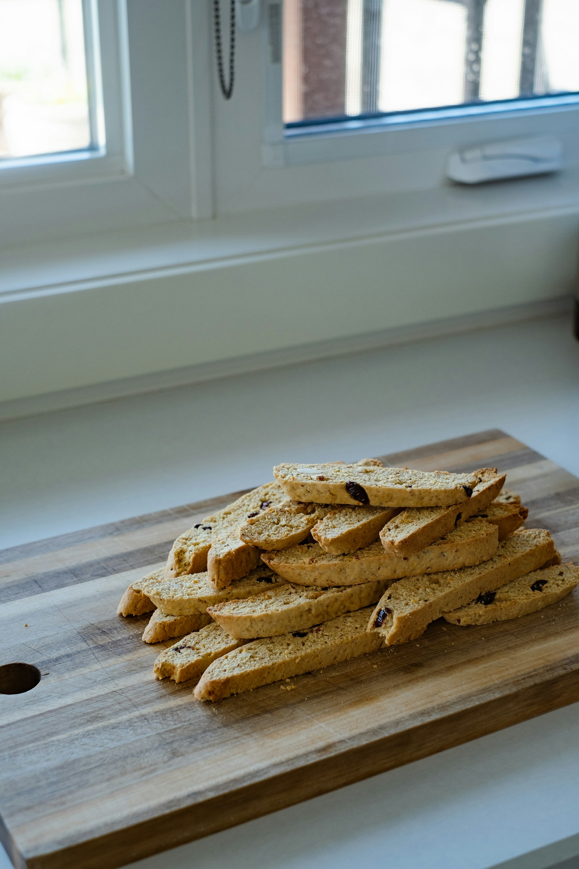 a pile of crackers sitting on top of a wooden cutting board