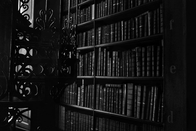 A dimly lit library filled with ancient books and candles.
