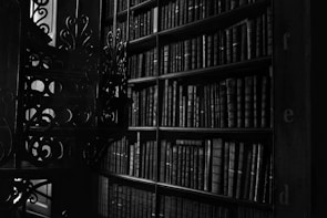 An eerie candlelit room filled with old books and artifacts.