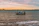 Fishing boat cutting through calm sea waters near Shengjin at sunrise