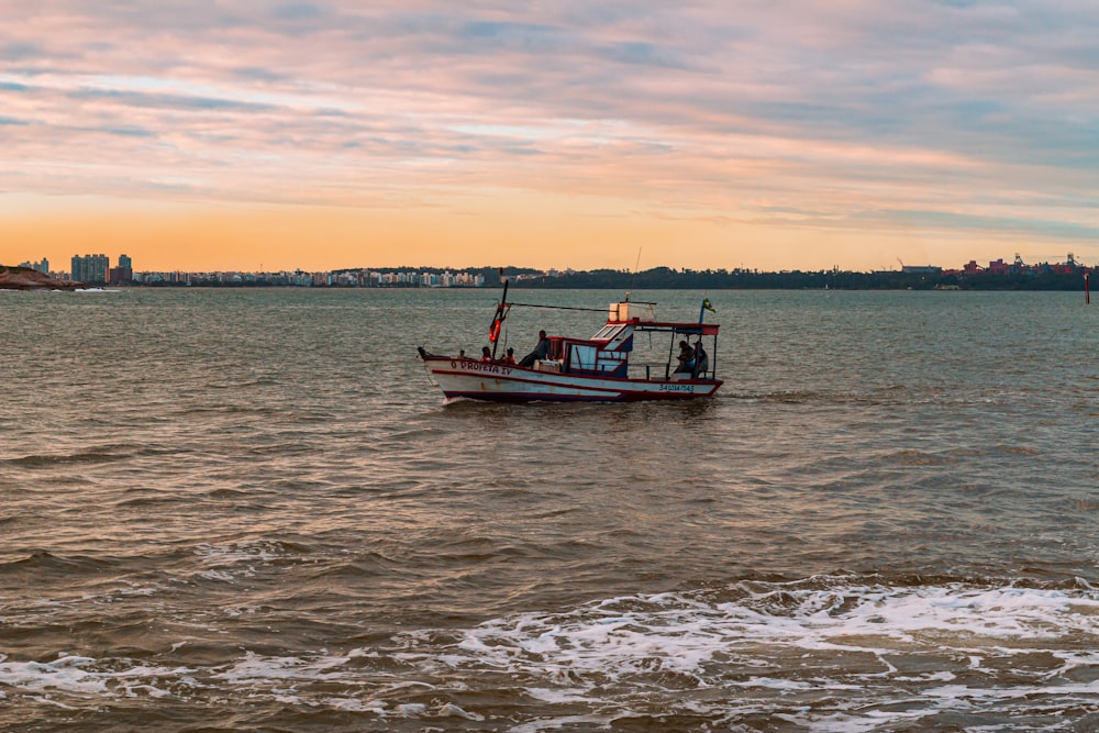 a small boat in the middle of a body of water