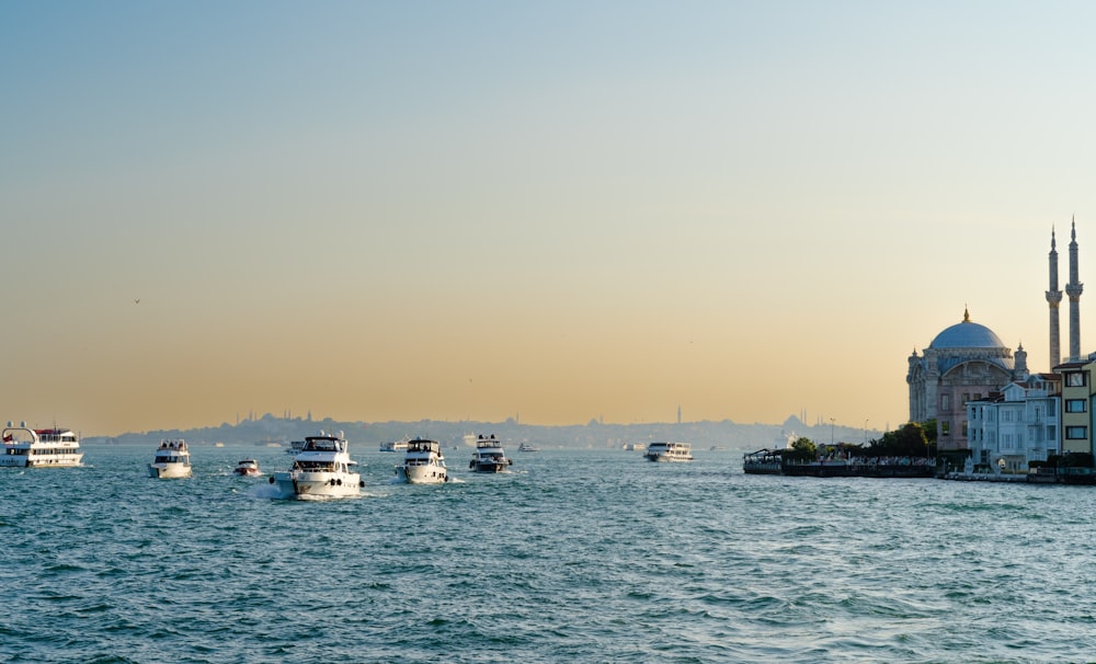 a group of boats floating on top of a large body of water