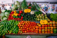 Close-up of fresh, colorful vegetables arranged artfully on a market stall.