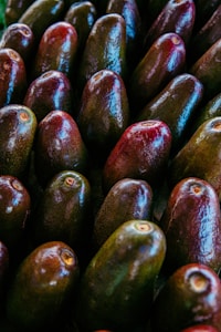 a pile of avocados sitting next to each other