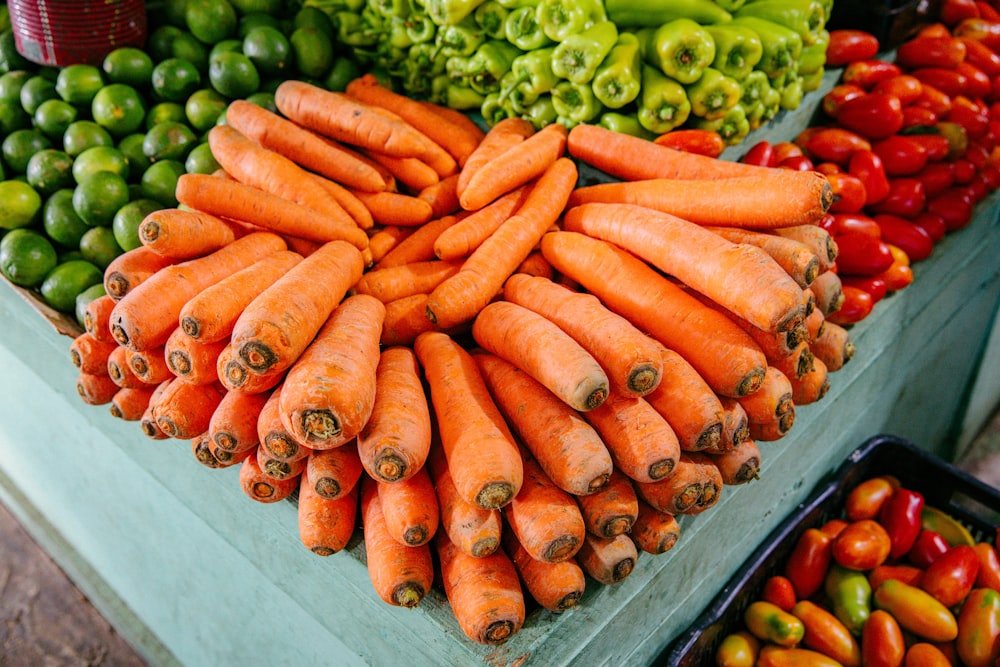 a display of carrots, peppers, and other vegetables