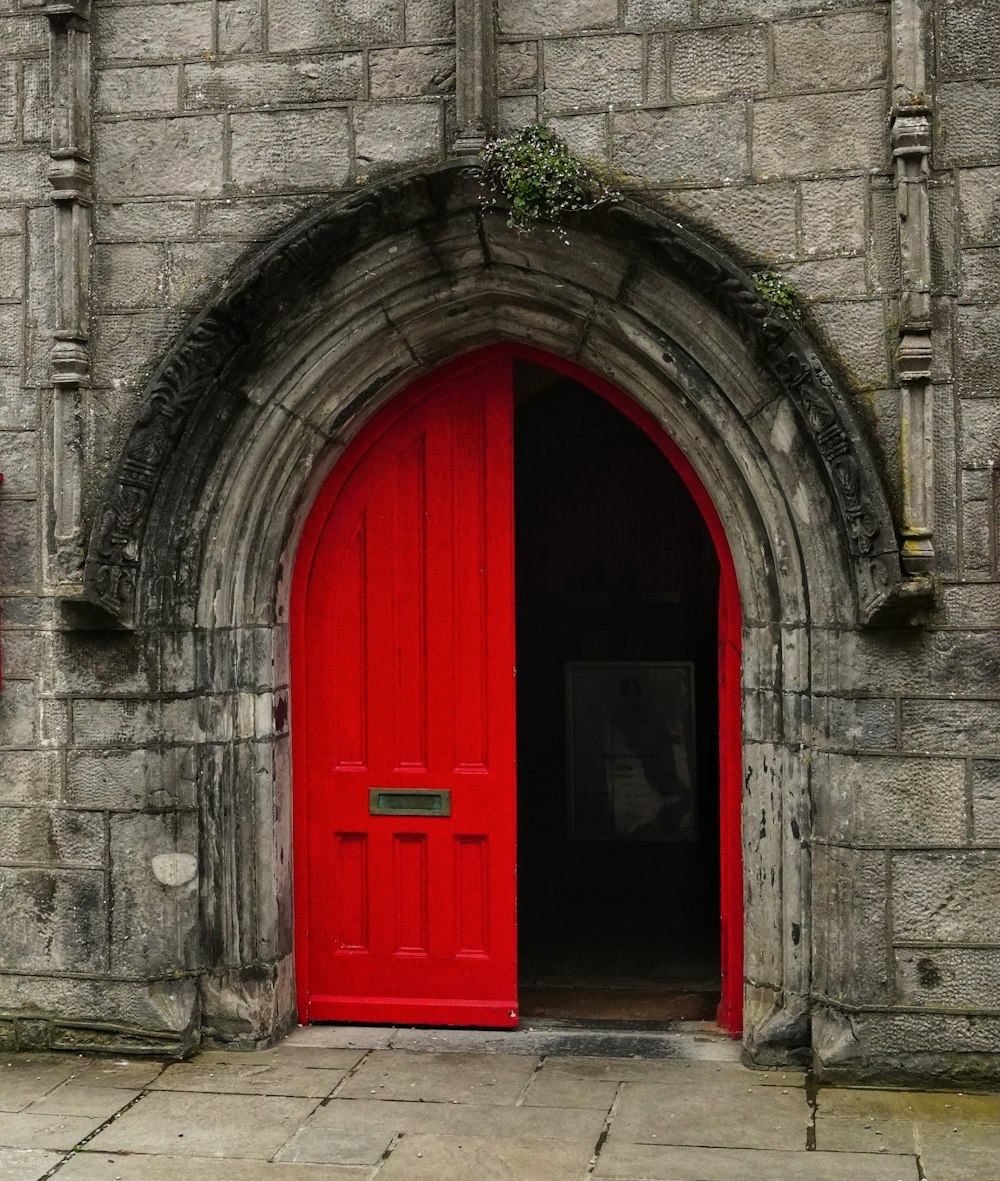 a red door in an old stone building