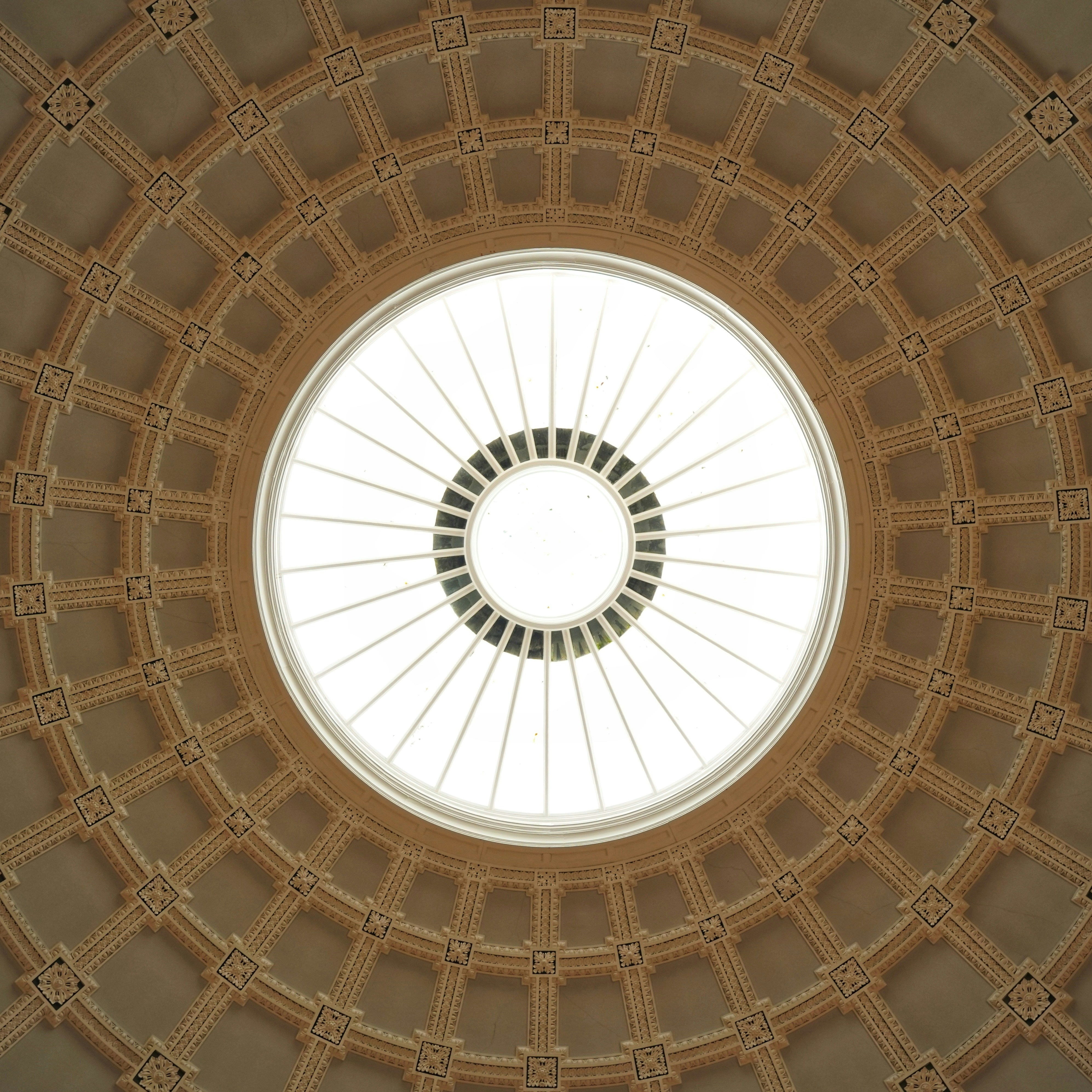 the ceiling of a building with a circular window