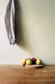 A rustic wooden table adorned with a checkered, country-style tablecloth.