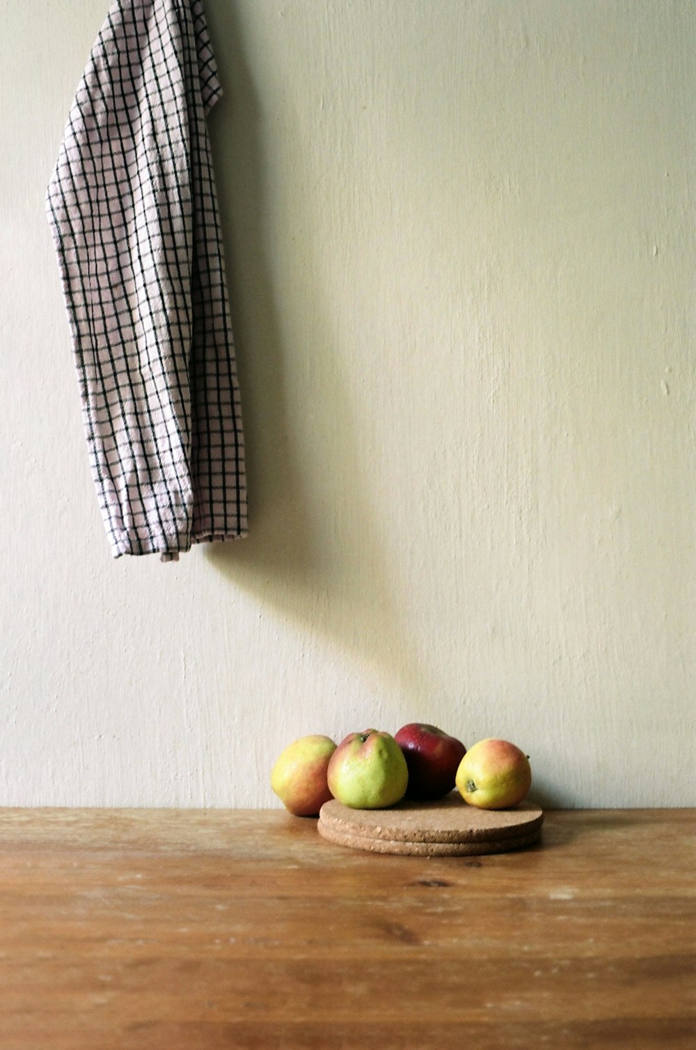 a wooden table topped with a bowl of fruit