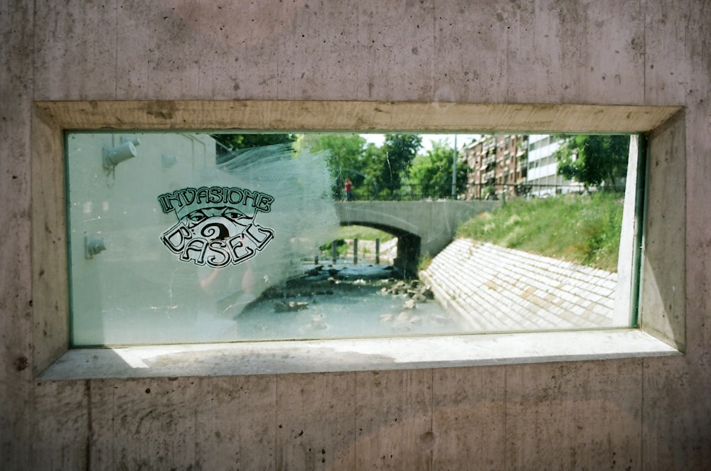 a reflection of a bridge in a window