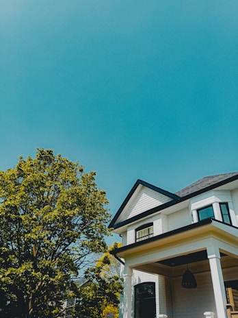 A freshly painted modern house exterior under a clear blue sky.