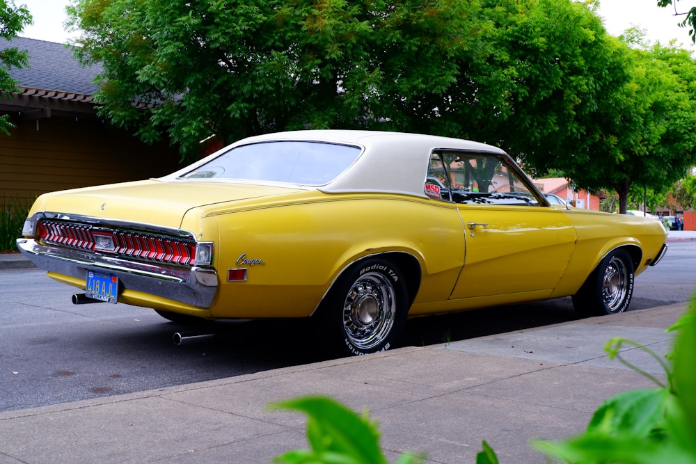 a yellow car parked on the side of the road