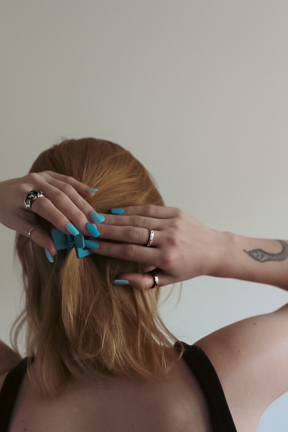 a woman with blue nail polish on her hands