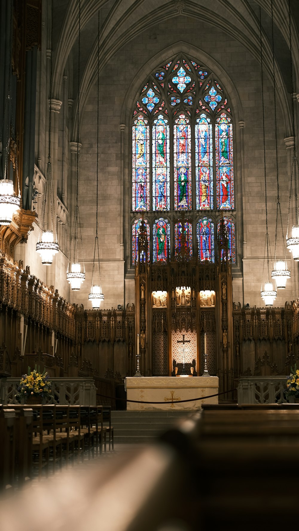 a church with a stained glass window and pews