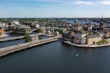 A sweeping aerial view of Liverpool's waterfront with boats and historic buildings.