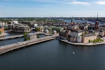 A sweeping aerial view of Liverpool's waterfront with boats and historic buildings.