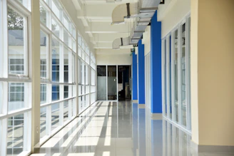Bright hospital corridor with natural light and calming blue and green accents.