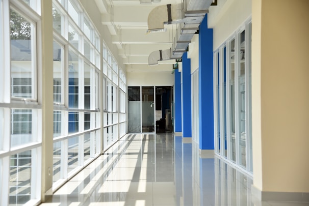 a long hallway with blue and white walls and windows