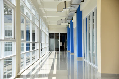 Bright hospital corridor with natural light and calming blue and green accents.