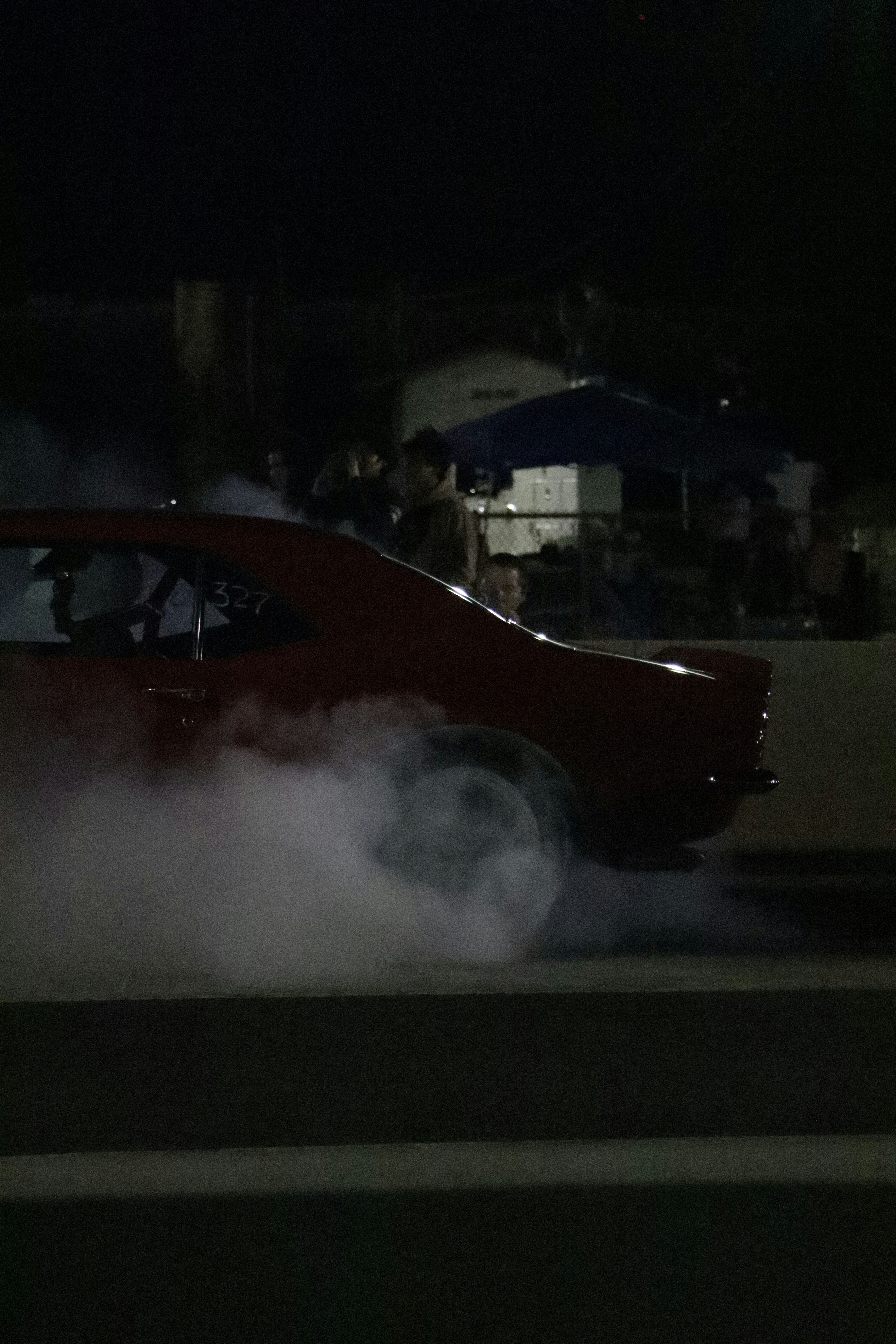 a red car with a lot of smoke coming out of it