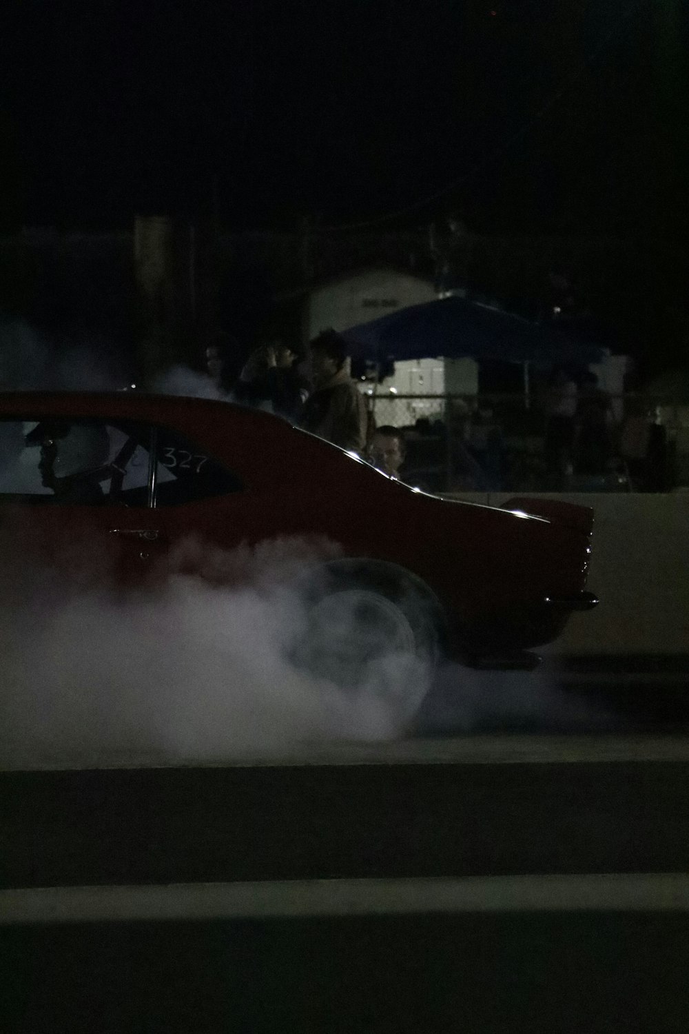 a red car with a lot of smoke coming out of it