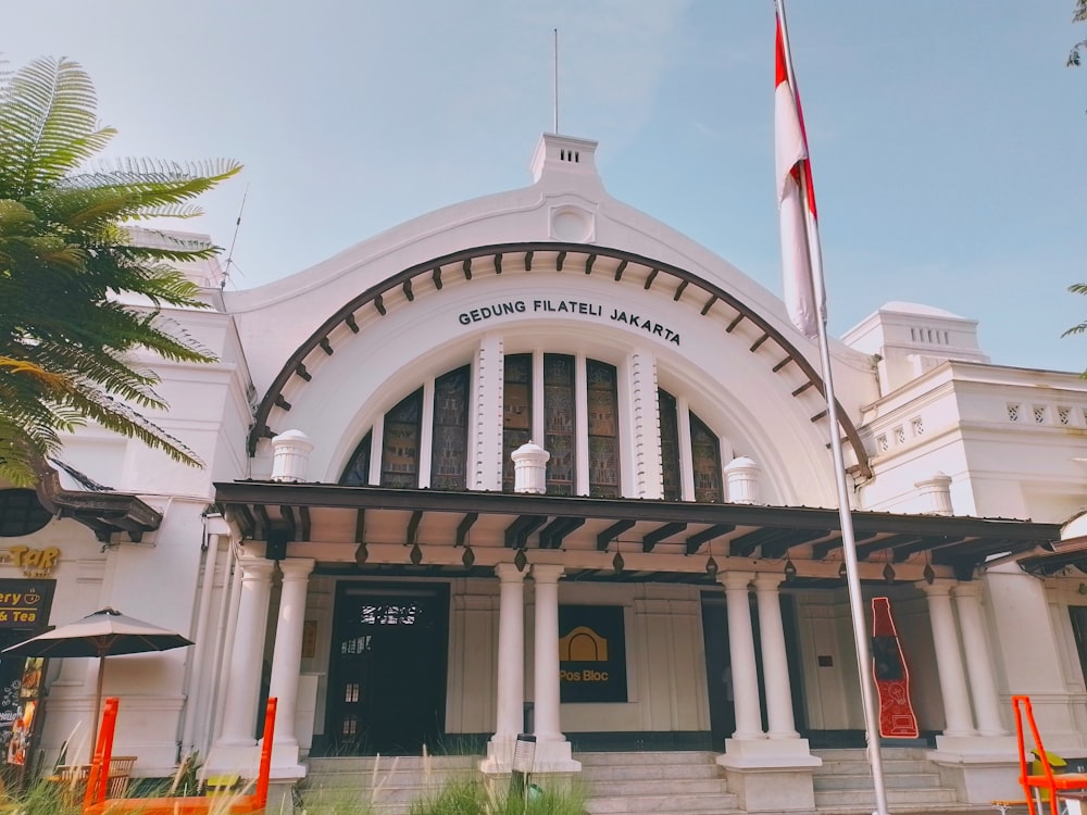 a large white building with a flag on top of it