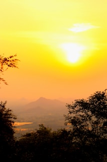 A serene landscape shot from a travel documentary, showcasing golden hour light over mountains.