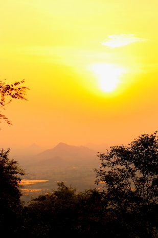 A serene landscape shot from a travel documentary, showcasing golden hour light over mountains.