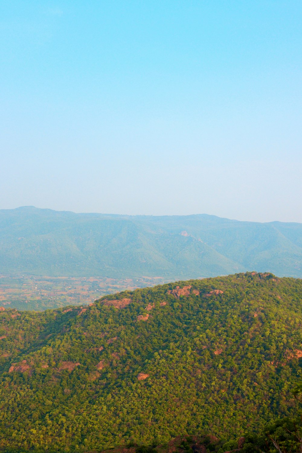 a view of the mountains from a hill top