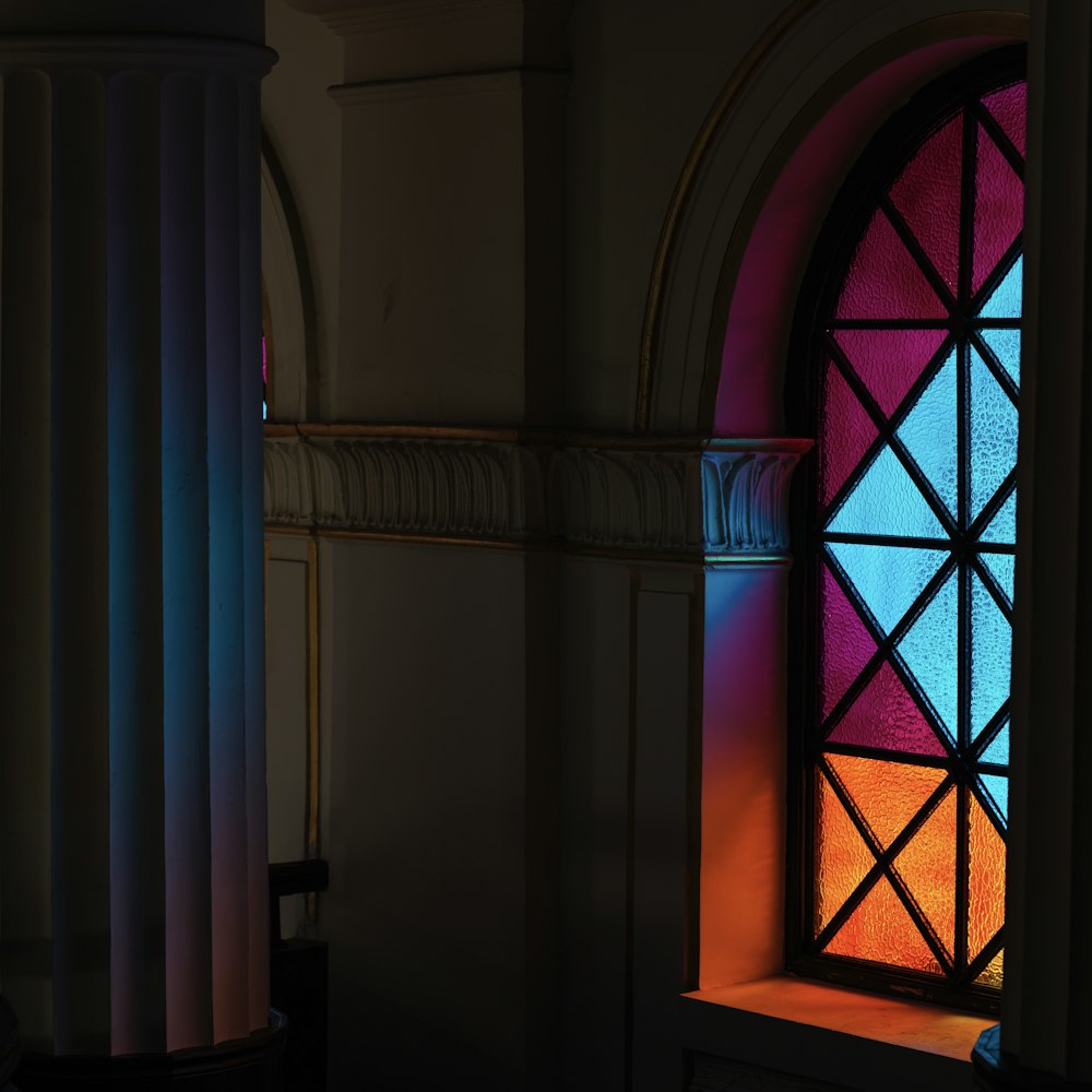 a stained glass window sitting inside of a building