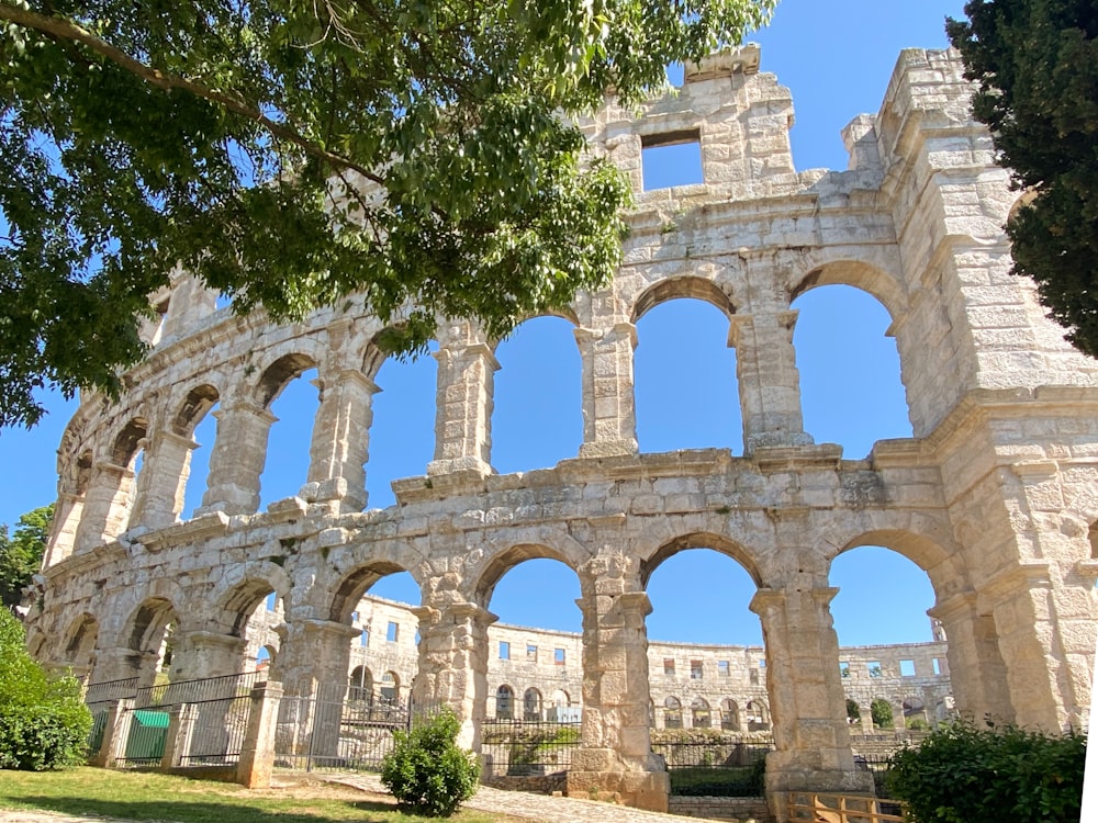 a large stone structure sitting under a tree