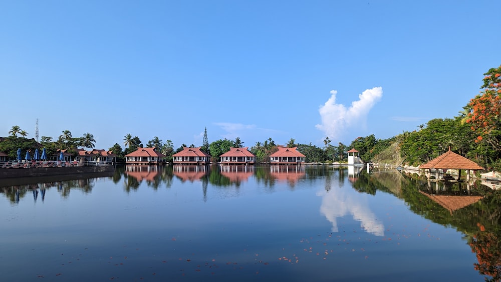 a body of water with houses in the background