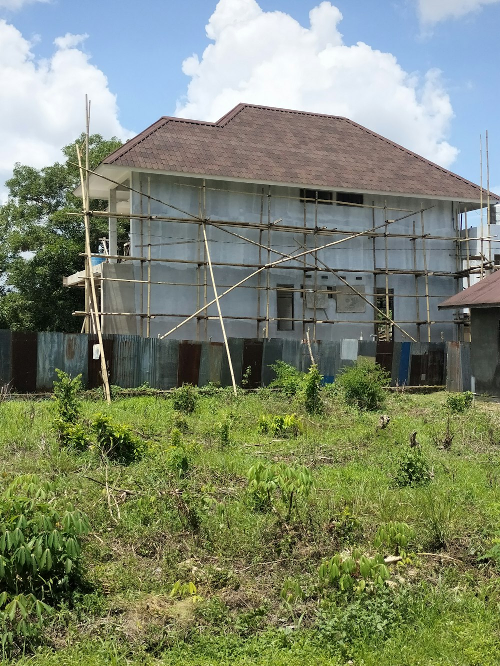 a house under construction with scaffolding around it