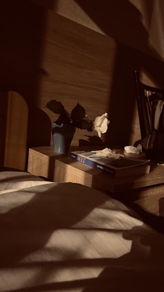 A cozy bedroom scene with a modular storage cube tucked under a bed, neatly holding books and keepsakes.
