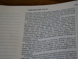 A close-up photograph of a page from the Bible, specifically Jeremiah 16:4. The text is printed in a serif font on white paper. The verses discuss themes of death and mourning.