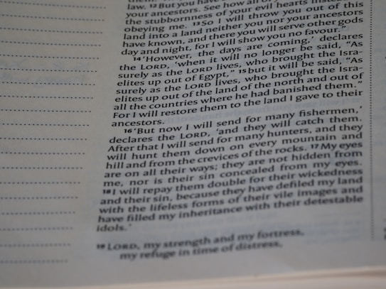 A close-up of a page from a religious text, featuring columns of typeset text with section numbers in bold. The focus is on specific passages discussing themes of prophecy and restoration.