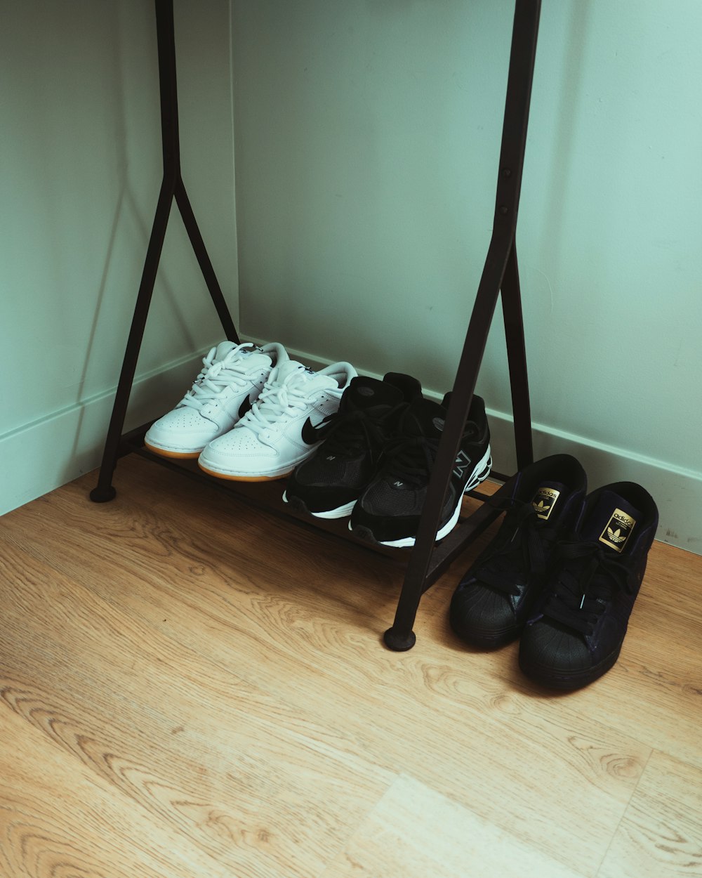 a pair of black and white shoes sitting on top of a wooden floor