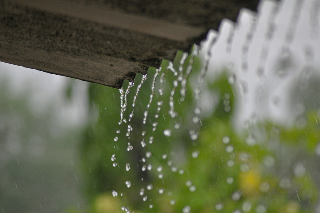 a rain gutter with water running down it,