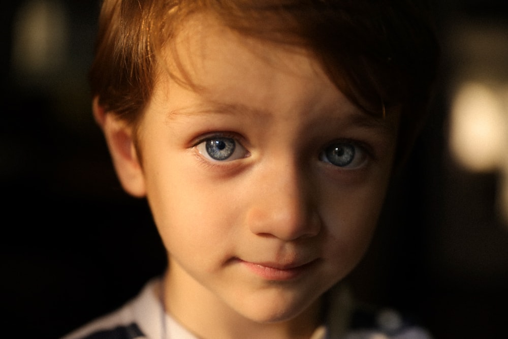 a close up of a child with blue eyes