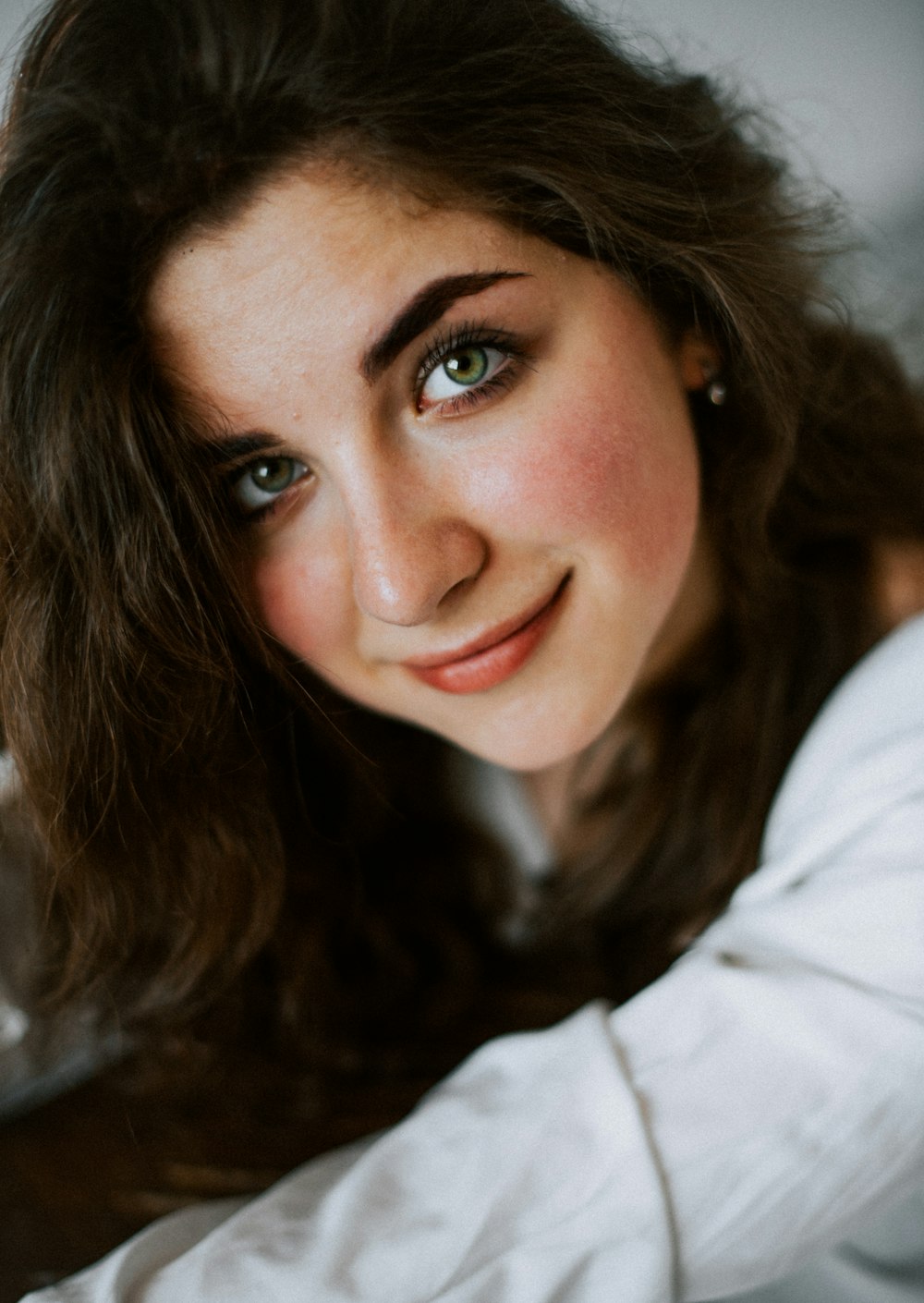 a close up of a person wearing a white shirt