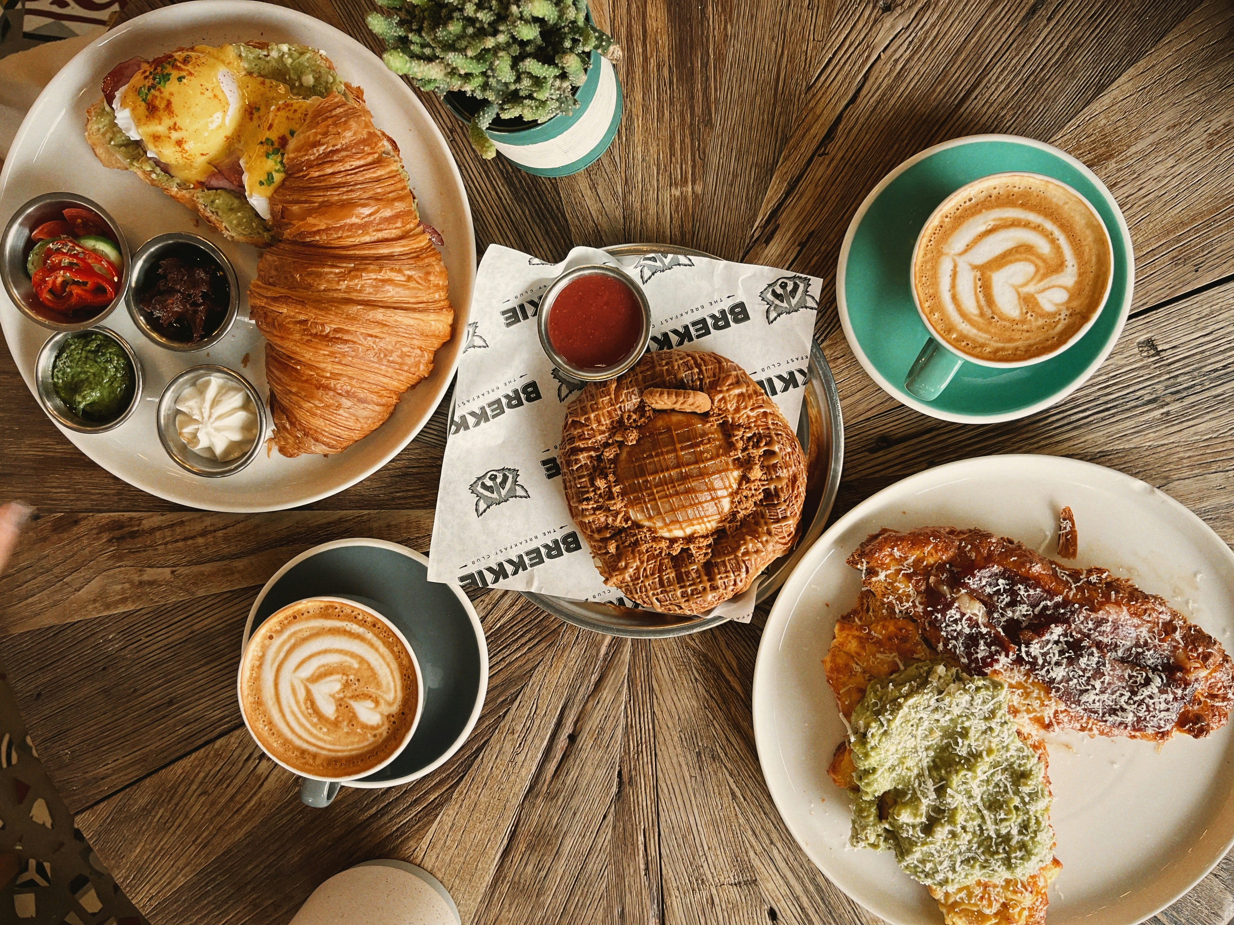 a wooden table topped with plates of food
