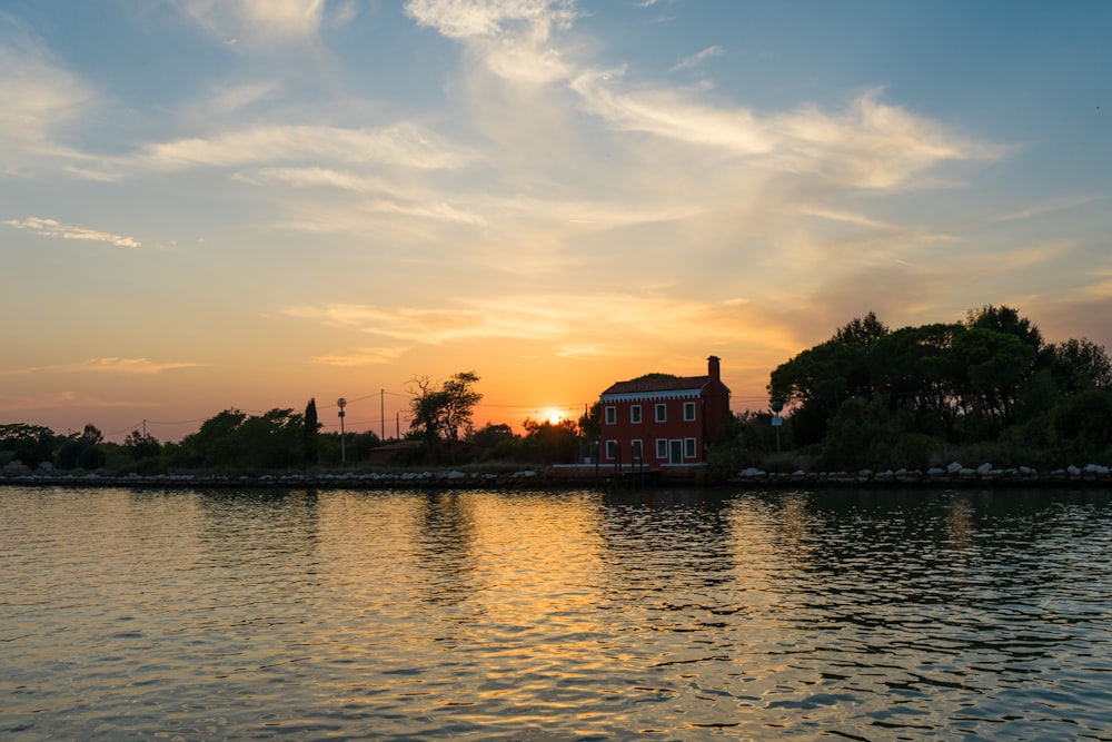 the sun is setting over a large body of water