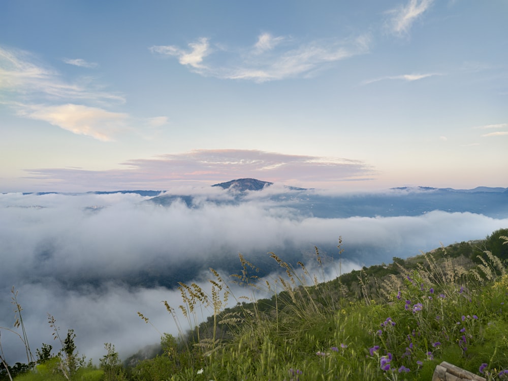 a view of a mountain with a few clouds in the sky