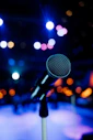 a microphone in front of a stage with lights