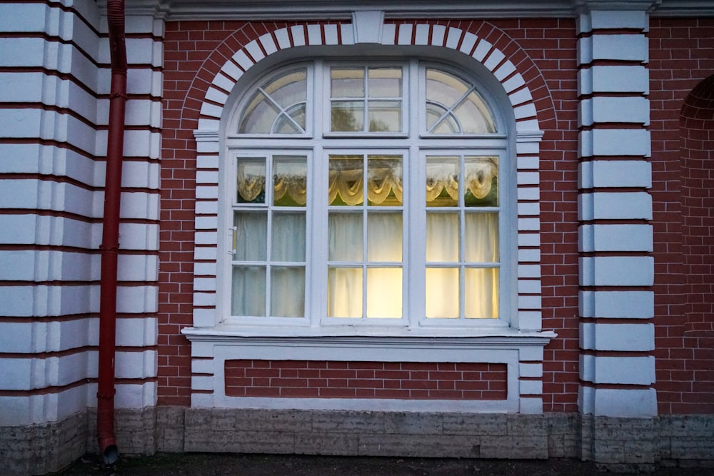 a red brick building with a white window