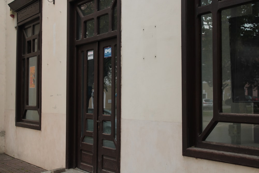 a building with two windows and a sign on the side of it