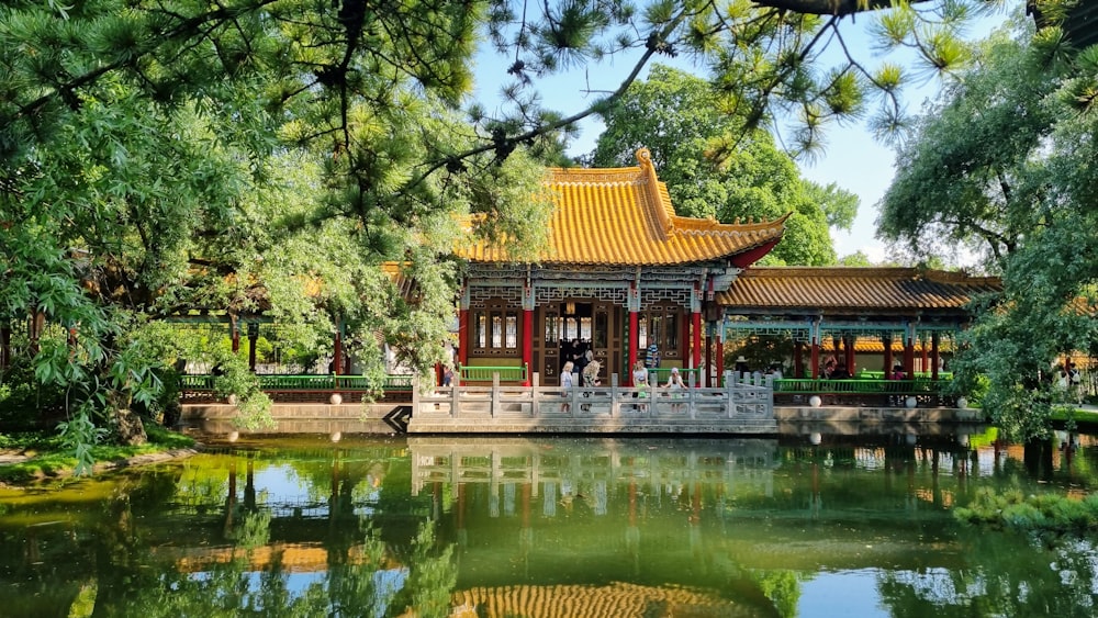a pavilion with a pond in front of it