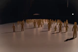 Close-up of colorful laser-cut figures arranged on a wooden table.