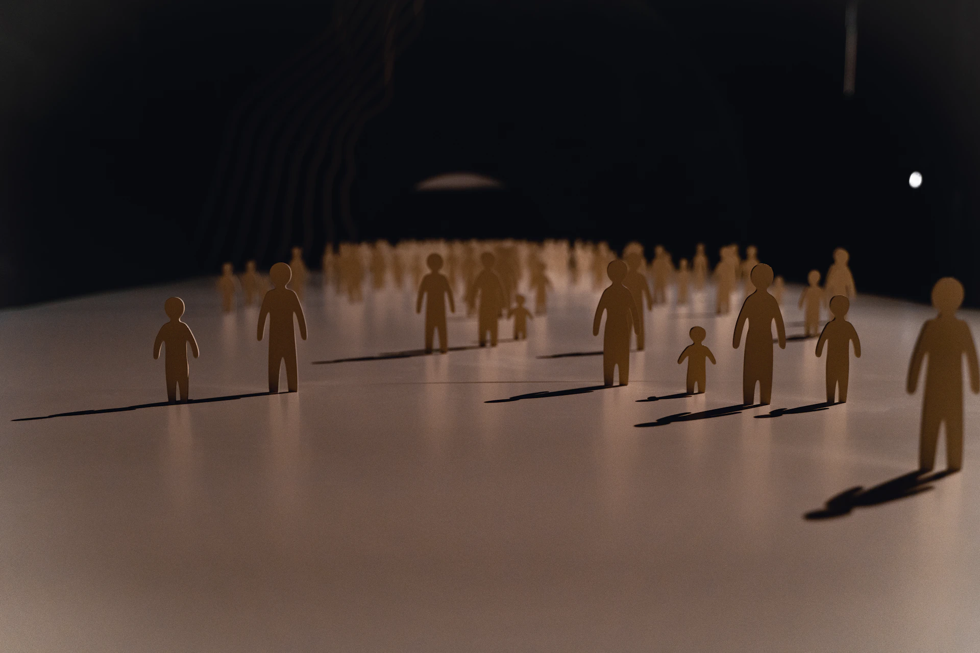 An outdoor installation featuring large wooden figures interacting with natural light and shadows.