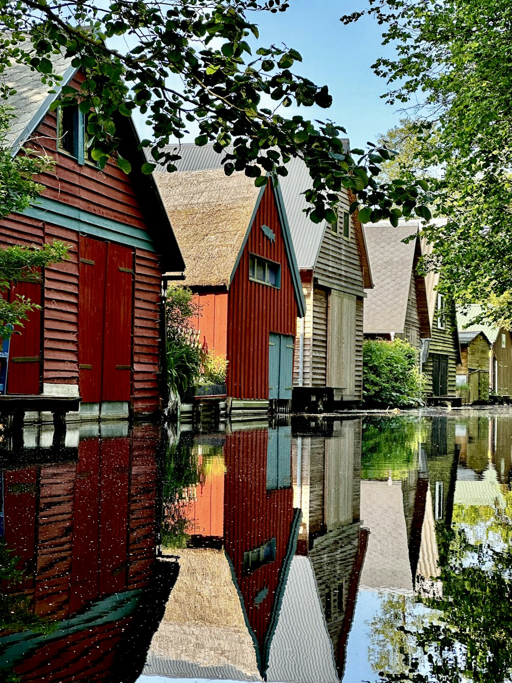 a row of houses sitting next to a body of water